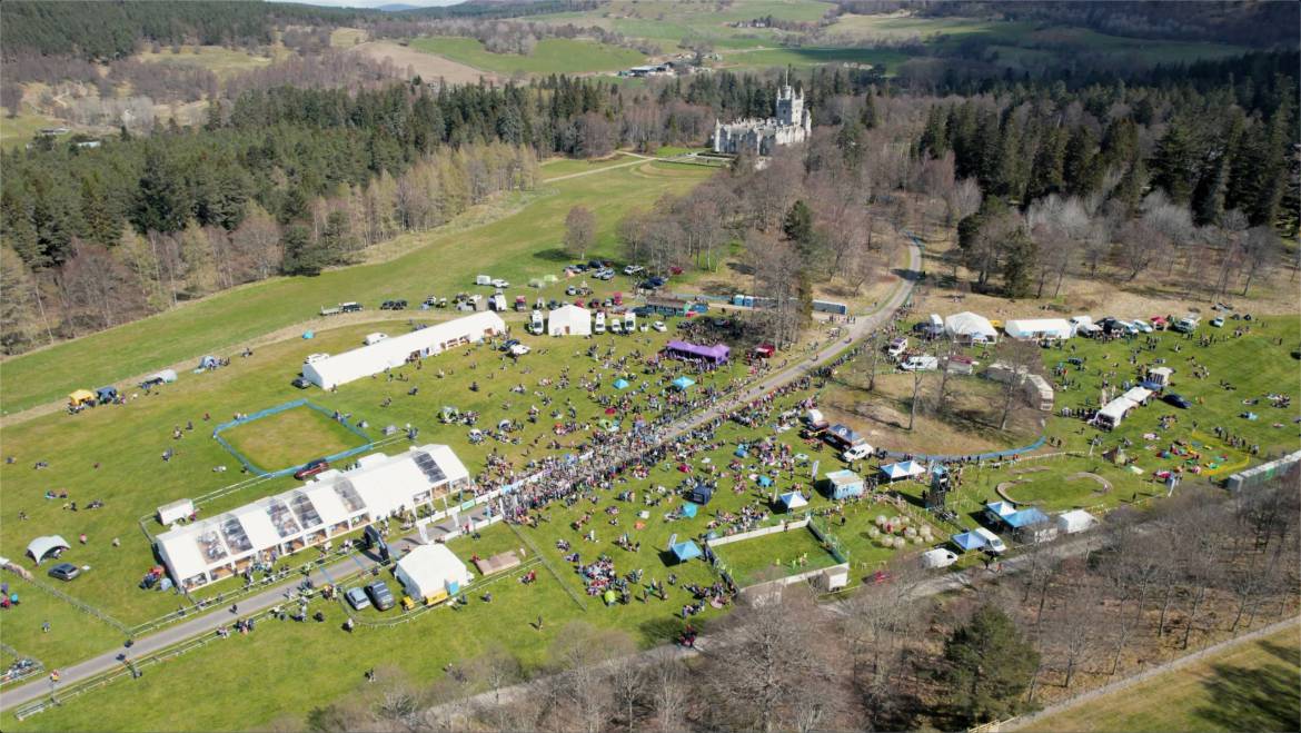 Event-Overview-with-Village-from-Drone-scaled.jpg